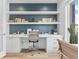 Stylish home office with a built-in desk, floating shelves, and bright natural light at 2107 S Grant St, Denver, CO 80210