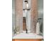 Chic powder room features stylish penny tile detail and updated vanity at 2107 S Grant St, Denver, CO 80210