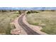 Scenic aerial view of a property showcasing a long driveway leading to a charming home nestled in a spacious landscape at 575 Heritage Trl, Elizabeth, CO 80107