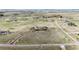 Expansive aerial shot reveals a home and garage situated on a vast lot, accented by a winding driveway at 575 Heritage Trl, Elizabeth, CO 80107