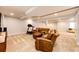 Open finished basement space with sitting area and exercise equipment at 575 Heritage Trl, Elizabeth, CO 80107