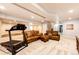 Finished basement area with sofas and a treadmill for exercise at 575 Heritage Trl, Elizabeth, CO 80107