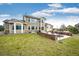 A rear exterior view of the house showcases a well-maintained lawn and inviting patio with a fire pit at 575 Heritage Trl, Elizabeth, CO 80107