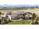 Inviting two-story home with a lush lawn, complemented by professional landscaping and a spacious detached garage at 575 Heritage Trl, Elizabeth, CO 80107