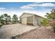 Spacious detached garage featuring neutral siding with stacked stone accents and ample parking on a large concrete pad at 575 Heritage Trl, Elizabeth, CO 80107