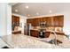 Modern kitchen featuring granite countertops, stainless steel appliances, and rich wood cabinetry at 575 Heritage Trl, Elizabeth, CO 80107