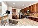 Stylish kitchen with stainless steel appliances, granite countertops, custom backsplash, and modern faucet at 575 Heritage Trl, Elizabeth, CO 80107