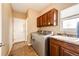 The laundry room features a stainless steel washer and dryer, sink, and overhead cabinets at 575 Heritage Trl, Elizabeth, CO 80107