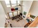 A living room with a fireplace, large windows, leather sofa, and vaulted ceiling is captured from above at 575 Heritage Trl, Elizabeth, CO 80107