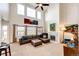 Bright and airy living room featuring tall ceilings, large windows, and a stone fireplace at 575 Heritage Trl, Elizabeth, CO 80107