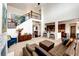 Open-concept living room with hardwood floors, comfortable seating, and a staircase to the second floor at 575 Heritage Trl, Elizabeth, CO 80107