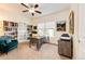 This office features a ceiling fan, natural light from the windows, a printer, and bookshelves at 575 Heritage Trl, Elizabeth, CO 80107