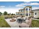 An inviting patio featuring a built-in grill, fire pit, outdoor seating, and a lush lawn at 575 Heritage Trl, Elizabeth, CO 80107