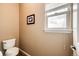 Powder room featuring neutral walls and tile flooring, toilet, and window at 575 Heritage Trl, Elizabeth, CO 80107