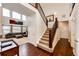 Elegant staircase with hardwood railings leading to the upper level at 575 Heritage Trl, Elizabeth, CO 80107