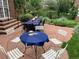 Entertaining backyard patio with two tables ready for outdoor dining, bordered by lush garden landscape at 1788 Glencoe St, Denver, CO 80220