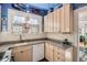 Charming kitchen featuring granite countertops, custom cabinets, and whimsical decor at 1788 Glencoe St, Denver, CO 80220