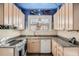 Bright kitchen with granite countertops and cabinets, featuring whimsical decor at 1788 Glencoe St, Denver, CO 80220