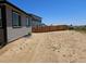Backyard with a gray home and a wood fence at 6066 Caribou Dr, Brighton, CO 80601