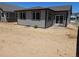 Exterior view of a home showing the backyard with minimal landscaping at 6066 Caribou Dr, Brighton, CO 80601