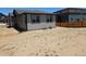 Backyard with a gray home and a sand lot for landscaping at 6066 Caribou Dr, Brighton, CO 80601