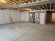 Unfinished basement with concrete floors and exposed ceiling at 6066 Caribou Dr, Brighton, CO 80601