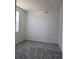Cozy bedroom with plush gray carpeting, natural light, and freshly painted walls at 6066 Caribou Dr, Brighton, CO 80601
