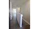 Bright hallway featuring hardwood floors and white walls leading towards other rooms at 6066 Caribou Dr, Brighton, CO 80601