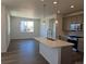 Modern kitchen featuring pendant lighting, stainless steel appliances, and a large island at 6066 Caribou Dr, Brighton, CO 80601