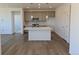 Bright open kitchen with a central island, stainless steel appliances, and pendant lighting at 6066 Caribou Dr, Brighton, CO 80601