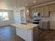 Modern kitchen featuring a large island with sink, neutral countertops and a range of appliances at 6066 Caribou Dr, Brighton, CO 80601