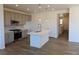 Modern kitchen featuring a large island with sink, neutral countertops, and stainless steel appliances at 6066 Caribou Dr, Brighton, CO 80601