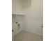 A clean laundry room featuring tile floors, connections for a washer and dryer and white walls at 6066 Caribou Dr, Brighton, CO 80601