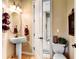 A neutral-toned bathroom features an oval mirror, pedestal sink, and decorative wall fixtures at 9298 Spirit Ct, Parker, CO 80138