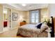 Comfortable bedroom featuring neutral tones, a window with blinds, and an ensuite bathroom at 9298 Spirit Ct, Parker, CO 80138
