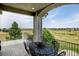 Covered patio with wrought iron railing, table, and expansive views at 9298 Spirit Ct, Parker, CO 80138