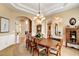 An elegant dining room with a large wood table and chandelier lighting fixture at 9298 Spirit Ct, Parker, CO 80138