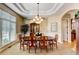 Formal dining room with large window, wainscoting, and elegant chandelier at 9298 Spirit Ct, Parker, CO 80138