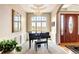 An elegant entryway with a grand piano, large front window and a decorative front door at 9298 Spirit Ct, Parker, CO 80138