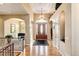 Grand foyer with a chandelier, hardwood floors, and an arched entryway at 9298 Spirit Ct, Parker, CO 80138