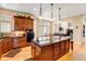Gourmet kitchen features wood cabinets, granite counters, stainless appliances, and large island with seating at 9298 Spirit Ct, Parker, CO 80138