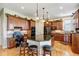 Open kitchen with an island, breakfast bar, stainless appliances and hardwood floors at 9298 Spirit Ct, Parker, CO 80138