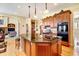 Spacious kitchen features hardwood floors, large island with granite countertops, and modern appliances at 9298 Spirit Ct, Parker, CO 80138