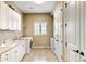 Bright laundry room with white cabinets, sink, washer, and dryer, offering convenience at 9298 Spirit Ct, Parker, CO 80138