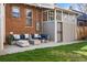 Backyard Patio with outdoor seating on a concrete slab with brick and enclosed porch at 1620 Dahlia St, Denver, CO 80220