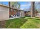 Spacious backyard with a well-manicured lawn and an outdoor seating area on a concrete patio at 1620 Dahlia St, Denver, CO 80220