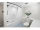 Renovated bathroom features new fixtures, a shower with a tiled surround and modern flooring at 1620 Dahlia St, Denver, CO 80220