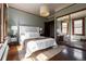 Sunlit bedroom featuring a mirrored closet door, hardwood floors, and neutral décor at 1620 Dahlia St, Denver, CO 80220