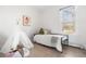 Cozy bedroom with a minimalist style featuring a daybed, teepee, and soft, neutral tones creating a peaceful atmosphere at 1620 Dahlia St, Denver, CO 80220
