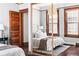 Spacious bedroom with hardwood floors, large windows, and ample natural light at 1620 Dahlia St, Denver, CO 80220